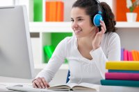 Student at desk with headphones on