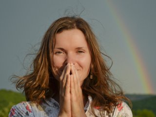 Woman standing in front of a rainbow, good fortune